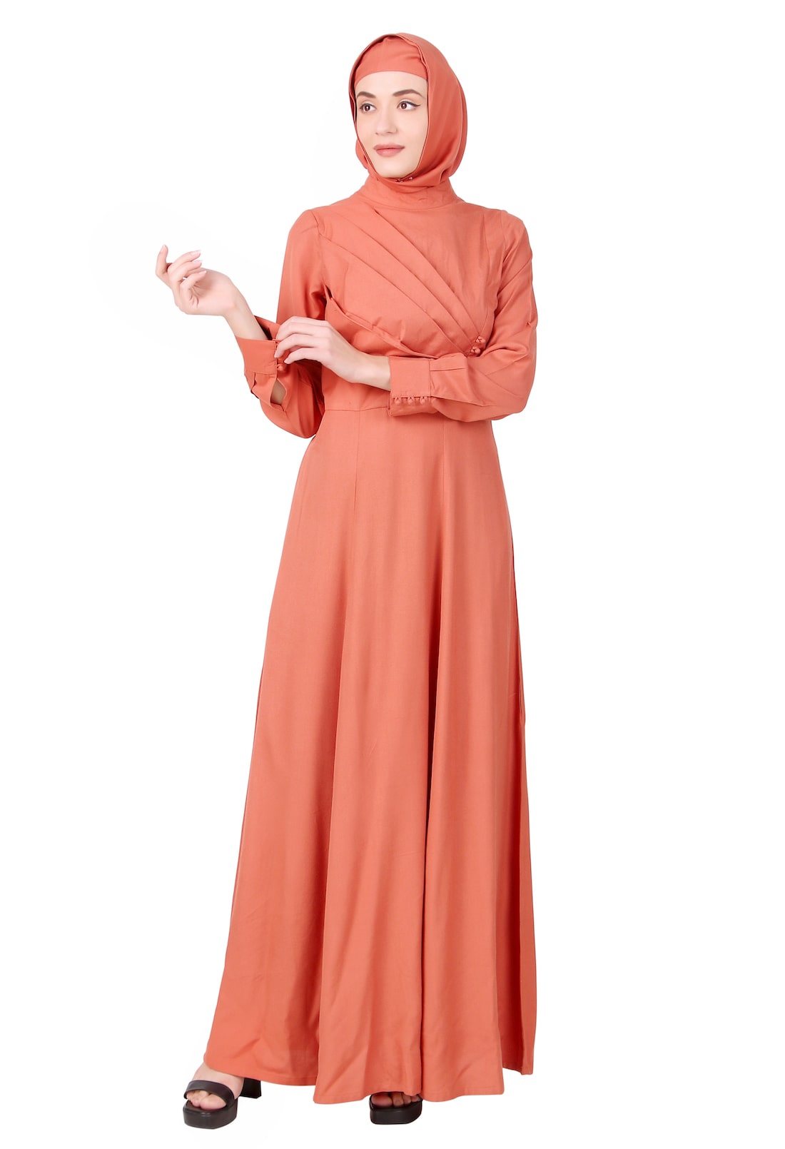 A woman wearing a redwood rayon abaya with a mandarin collar and straight sleeves, paired with a matching square hijab.