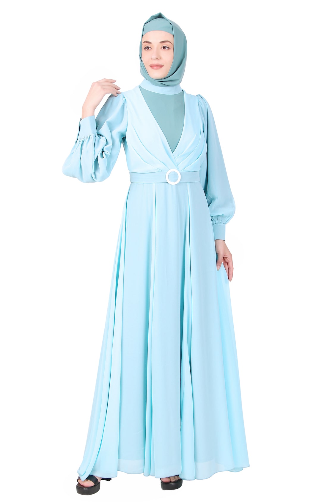 A woman wearing a turquoise and sea green Nida & Georgette relaxed fit abaya with a mandarin collar and straight sleeves with puckered cuffs. She is also wearing a matching square hijab.
