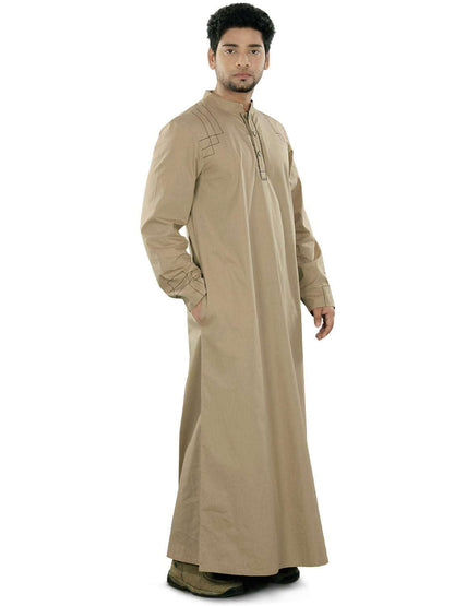 A man standing and facing the camera, wearing a beige traditional kurta with a band collar, front open placket with button closure, and running stitch design on the shoulders.