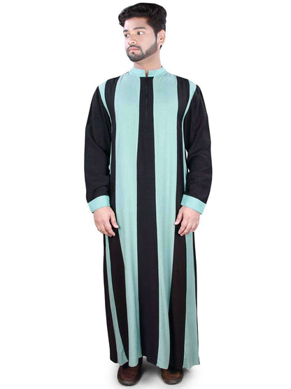A man wearing a black and sky-blue striped Liban Galabiyya with a band collar and zip closure in front, standing against a white background.