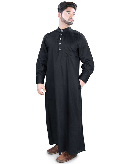 A man wearing a black traditional Galabiyya with a V-neck collar, front open placket, and button closure. He is also wearing brown leather shoes.