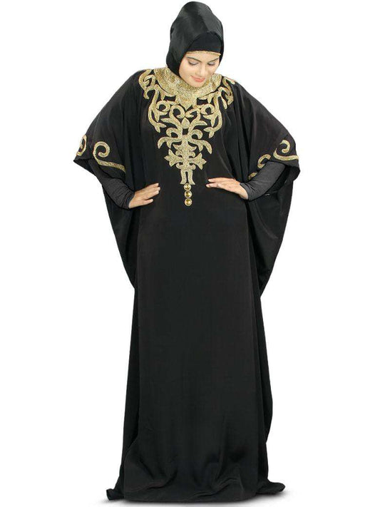 A woman wearing a black Kaftan with hand embroidery work on the neck and sleeves, featuring a band collar neckline and an adjustable belt at waist line.