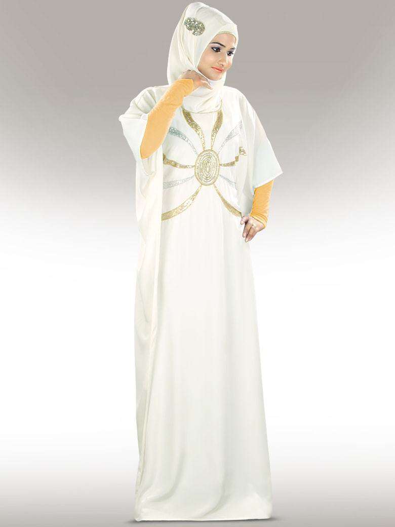 A model wearing an off-white hand embroidered Kaftan with silver and gold details, featuring a round neckline and adjustable belt at the waist.