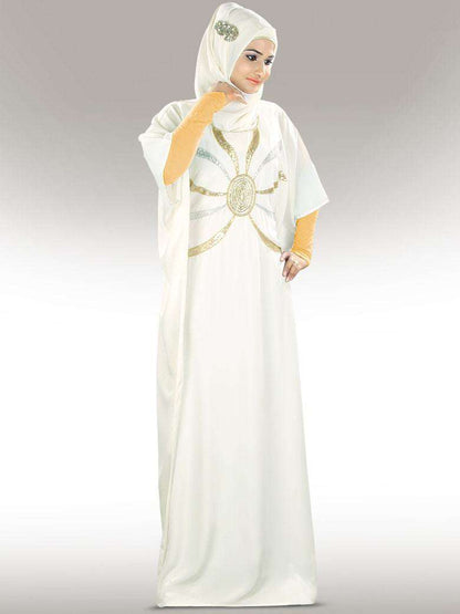 A model wearing an off-white hand embroidered Kaftan with silver and gold details, featuring a round neckline and adjustable belt at the waist.